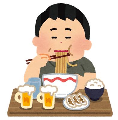 ラーメン・ご飯・餃子を食べながらビールを飲んでいる男性